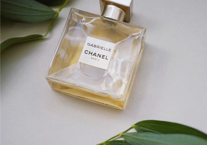 A perfume with some tree leaves.